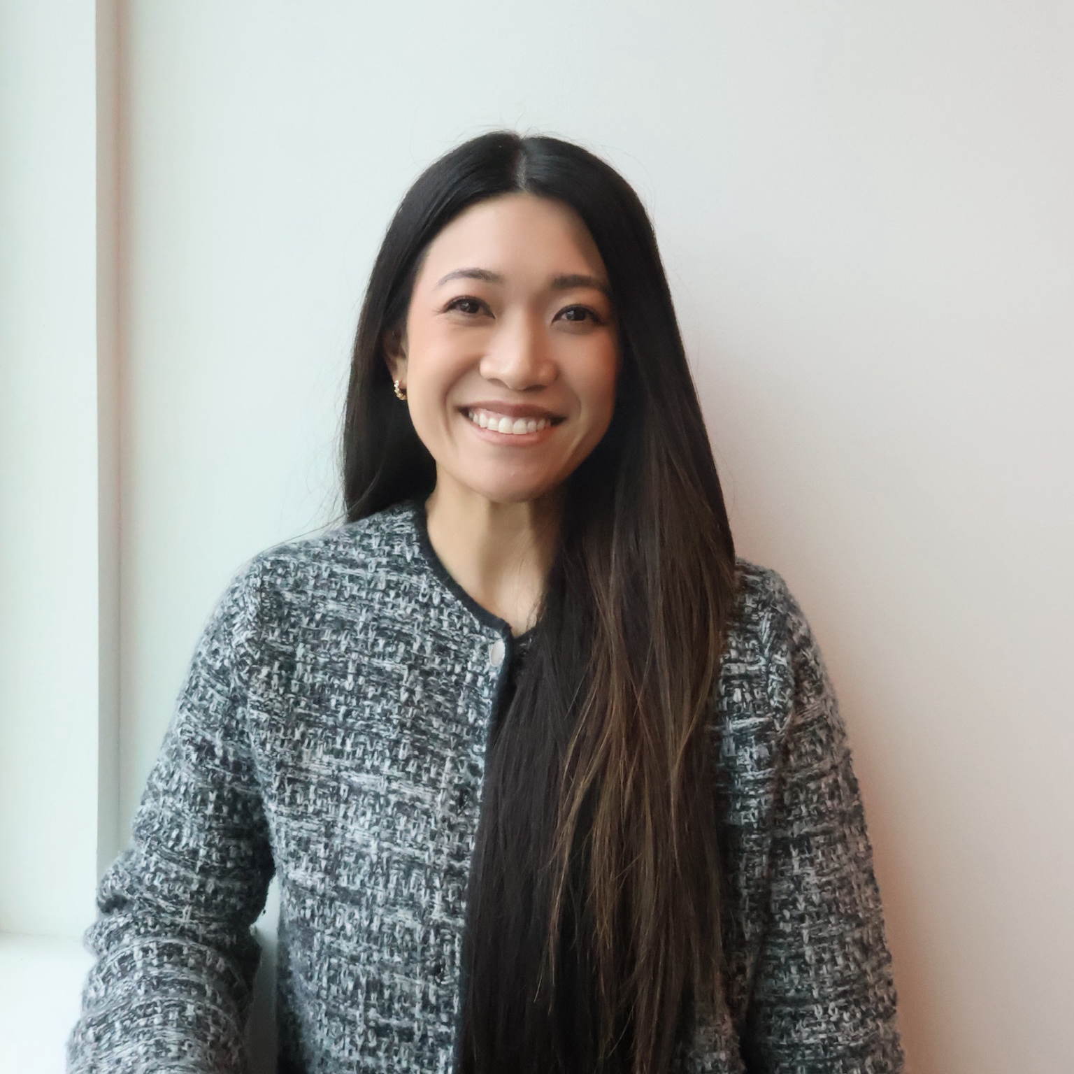 Ashleypic-cropped Staff member with long dark hair and gray blazer smiles at camera.